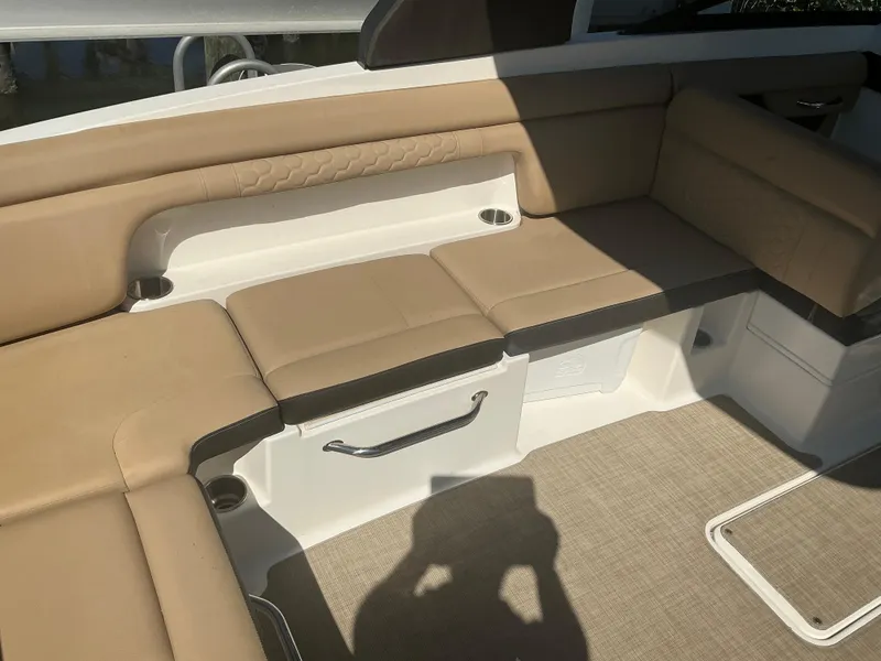 Slide: The Image of 2018 Sea Ray SDX 290 Outboard interior with tan seating and carpeted flooring. - 27