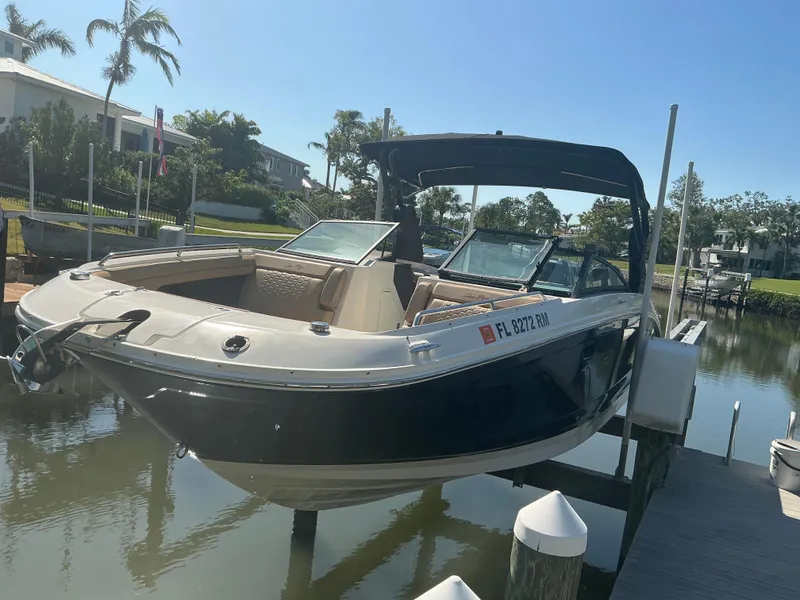 Slide: The Image of 2018 Sea Ray SDX 290 Outboard boat docked in a sunny marina setting. - 3