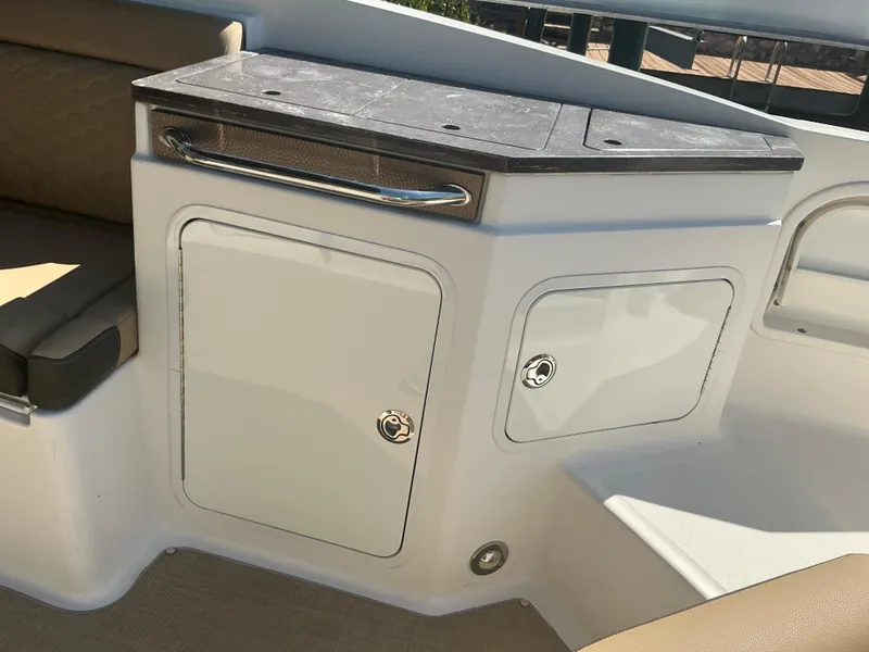 Slide: The Image of 2018 Sea Ray SDX 290 Outboard boat interior with storage compartments and seating area. - 30