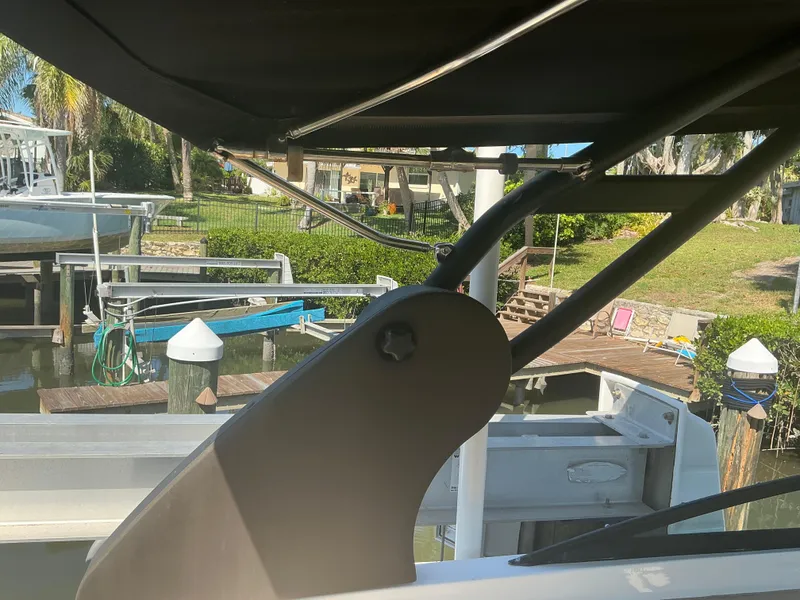 Slide: The Image of 2018 Sea Ray SDX 290 Outboard boat docked, featuring canopy and marina background. - 34