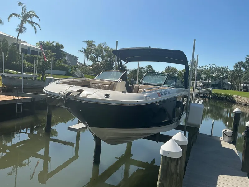 Slide: The Image of 2018 Sea Ray SDX 290 Outboard boat docked in a sunny marina setting. - 37