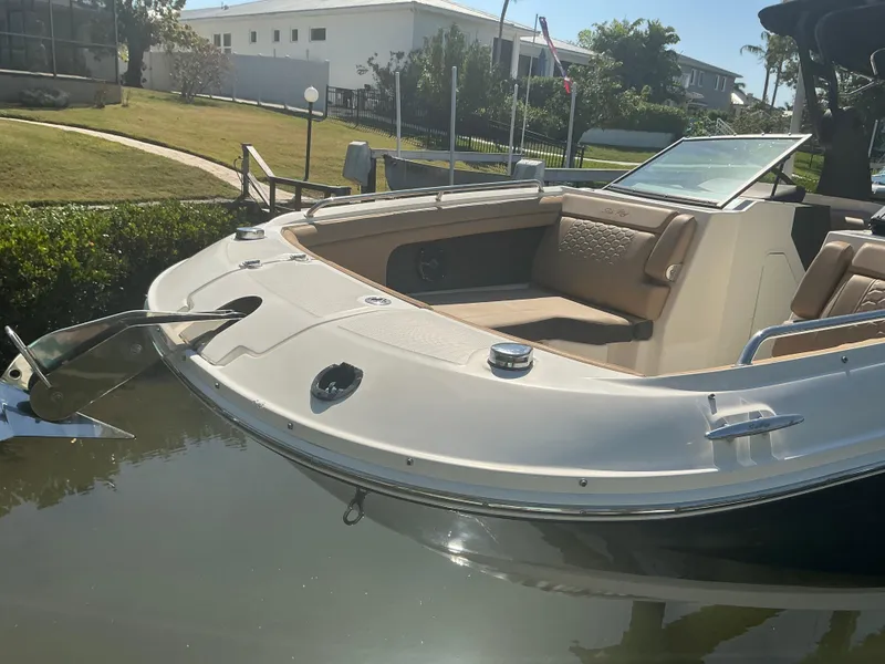 Slide: The Image of 2018 Sea Ray SDX 290 Outboard boat docked, featuring spacious seating and sleek design. - 5