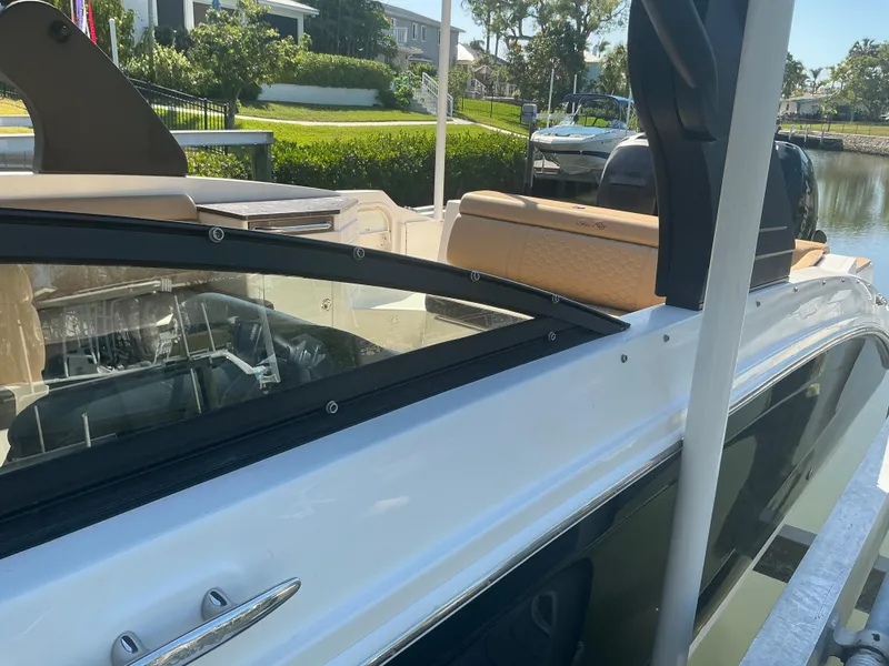 Slide: The Image of 2018 Sea Ray SDX 290 Outboard boat docked by waterfront homes. - 6