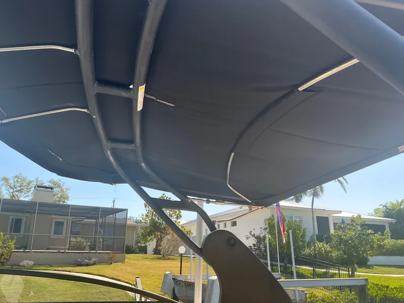 Slide: The Image of 2018 Sea Ray SDX 290 Outboard boat canopy, with residential background. - 7