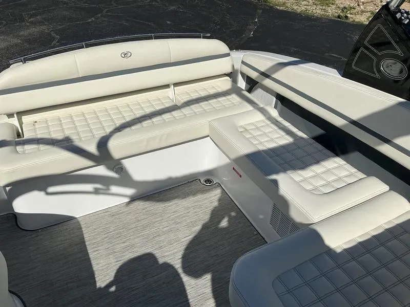 Slide: The Image of 2021 Cobalt R7 boat interior with white cushioned seating and gray flooring. - 10
