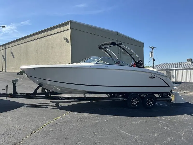 Slide: The Image of 2021 Cobalt R7 boat on trailer, parked outdoors, clear sky background. - 5