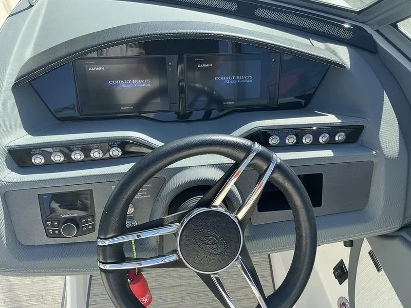 Slide: The Image of 2021 Cobalt R7 boat dashboard with steering wheel and Garmin displays. - 6