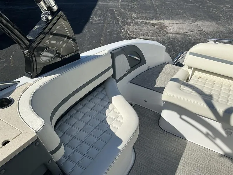 Slide: The Image of 2021 Cobalt R7 boat interior with white cushioned seating and sleek design. - 9