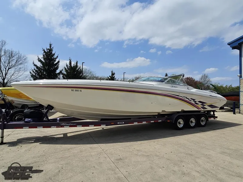 Slide: The Image of 1999 Powerquest 380 Avenger boat on trailer, under clear blue sky. - 17
