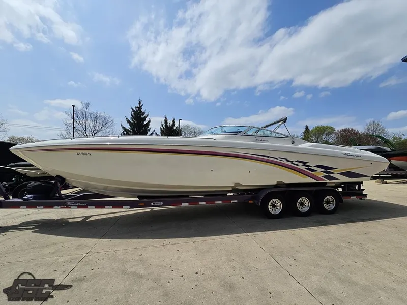 Slide: The Image of 1999 Powerquest 380 Avenger boat on trailer under a partly cloudy sky. - 18