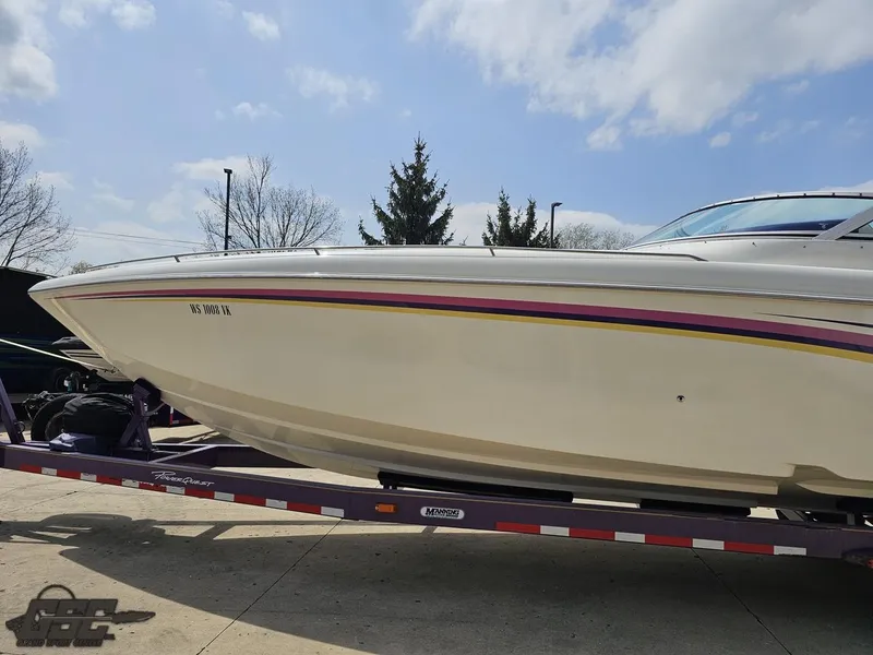 Slide: The Image of 1999 Powerquest 380 Avenger boat on trailer under a partly cloudy sky. - 19
