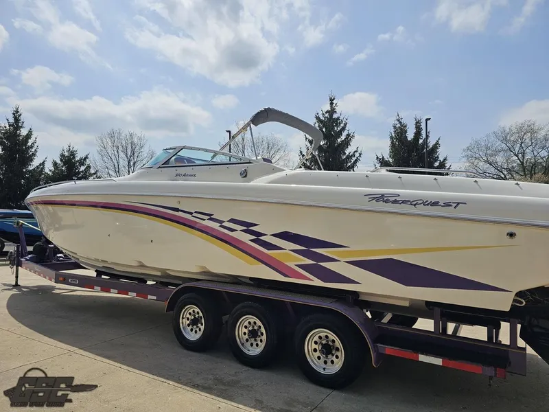 Slide: The Image of 1999 Powerquest 380 Avenger boat on trailer, featuring vibrant purple and yellow graphics. - 23