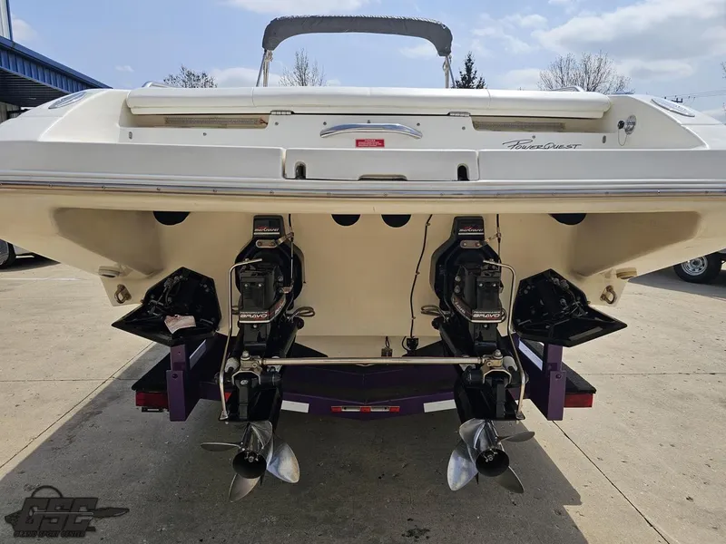 Slide: The Image of 1999 Powerquest 380 Avenger boat, rear view showing dual propellers and outboard motors. - 26