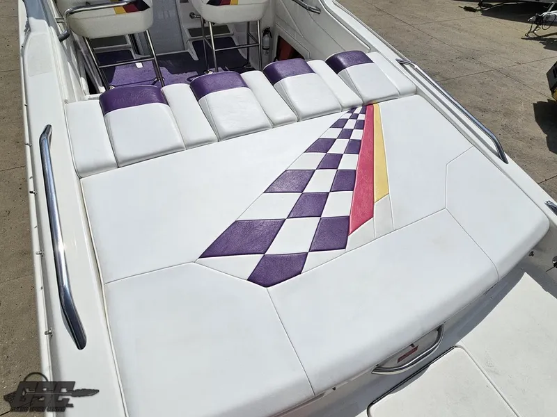 Slide: The Image of 1999 Powerquest 380 Avenger boat with colorful checkered upholstery design on the deck. - 32