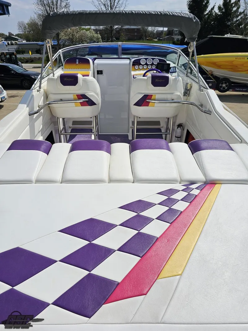 Slide: The Image of 1999 Powerquest 380 Avenger boat interior with colorful seating and dashboard. - 35