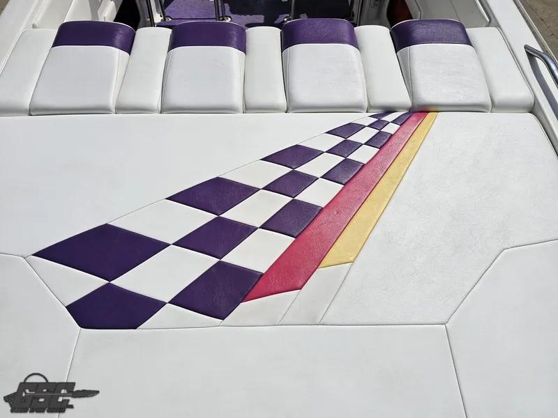 Slide: The Image of 1999 Powerquest 380 Avenger boat interior with colorful checkered pattern upholstery. - 36