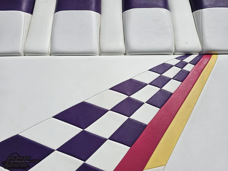 Slide: The Image of 1999 Powerquest 380 Avenger interior with purple, white, and checkered pattern upholstery design. - 37