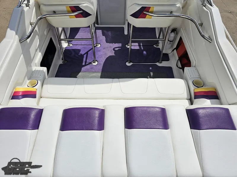 Slide: The Image of 1999 Powerquest 380 Avenger boat interior with white and purple seating. - 38