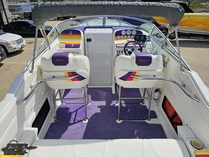 Slide: The Image of 1999 Powerquest 380 Avenger boat interior with purple accents and dual seating. - 40