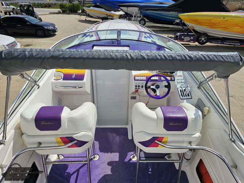 Slide: The Image of 1999 Powerquest 380 Avenger boat interior with purple and white seating and dashboard. - 41