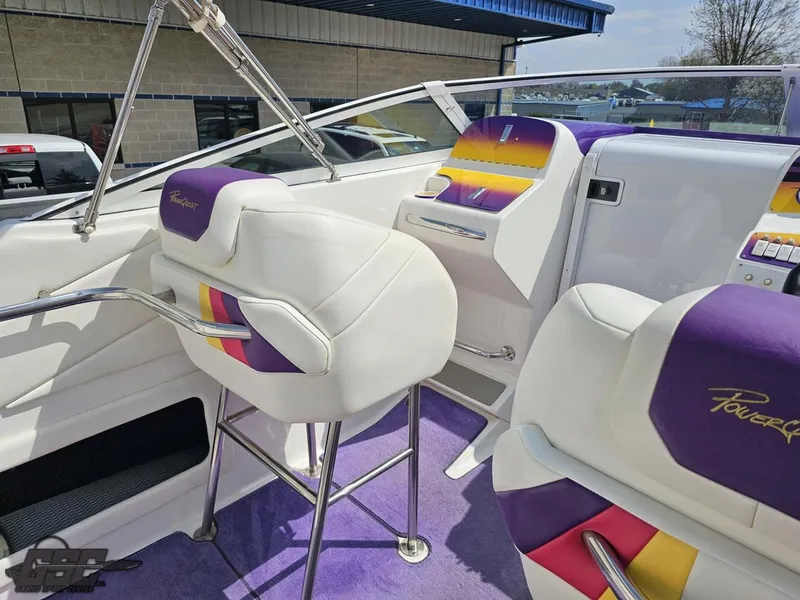 Slide: The Image of 1999 Powerquest 380 Avenger boat interior with colorful seating and modern dashboard. - 44
