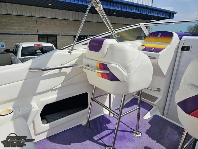 Slide: The Image of 1999 Powerquest 380 Avenger boat interior with purple and white seating and vibrant accents. - 46