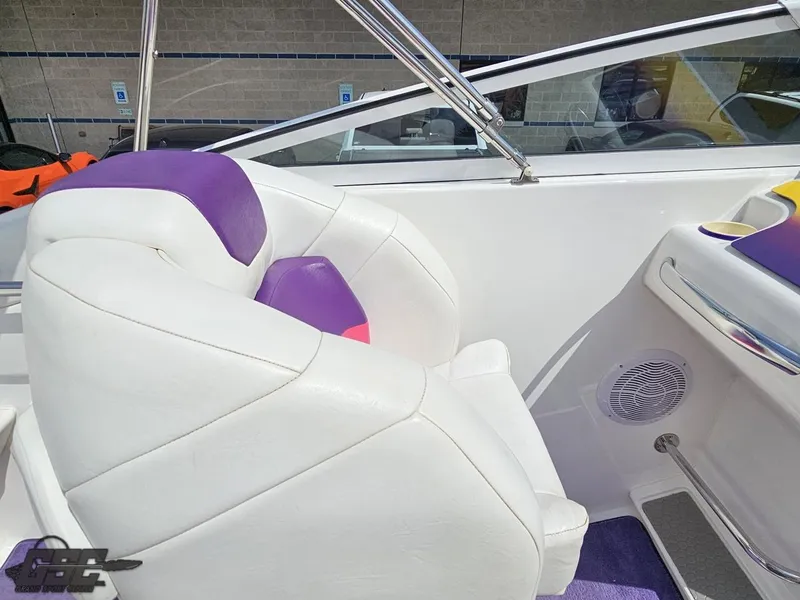 Slide: The Image of 1999 Powerquest 380 Avenger boat interior with white and purple seating. - 49
