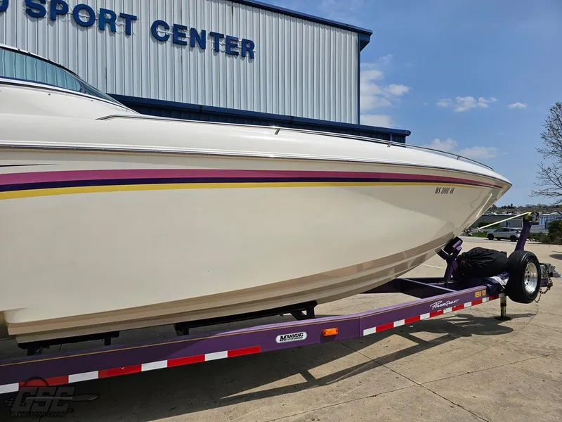 Slide: The Image of 1999 Powerquest 380 Avenger boat on trailer outside a sports center. - 5