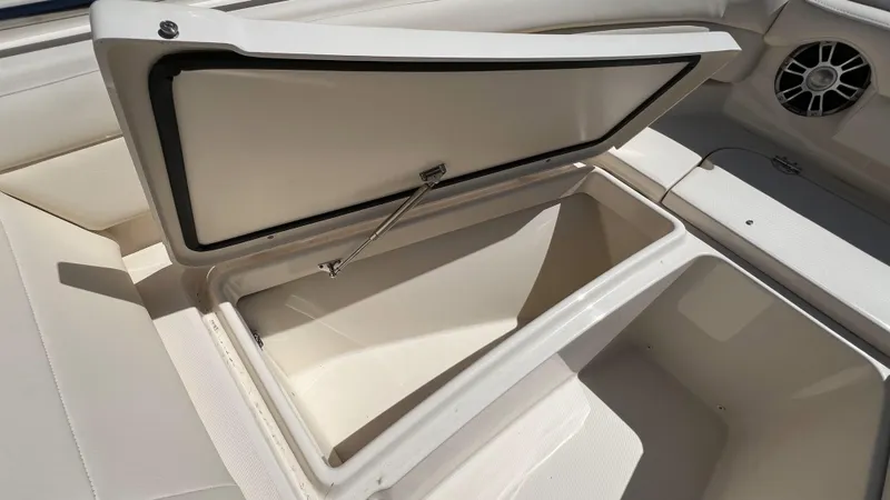 Slide: The Image of 2026 Grady-White GW 235 Freedom boat storage compartment, open lid, spacious interior. - 11