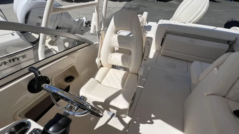 Slide: The Image of 2026 Grady-White GW 235 Freedom boat interior with steering wheel and seating. - 13