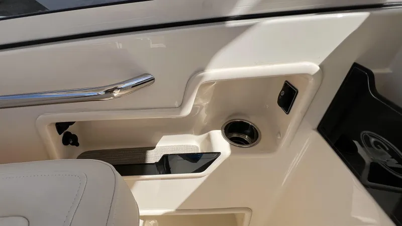 Slide: The Image of Interior detail of 2026 Grady-White GW 235 Freedom boat, featuring sleek design and cup holder. - 16