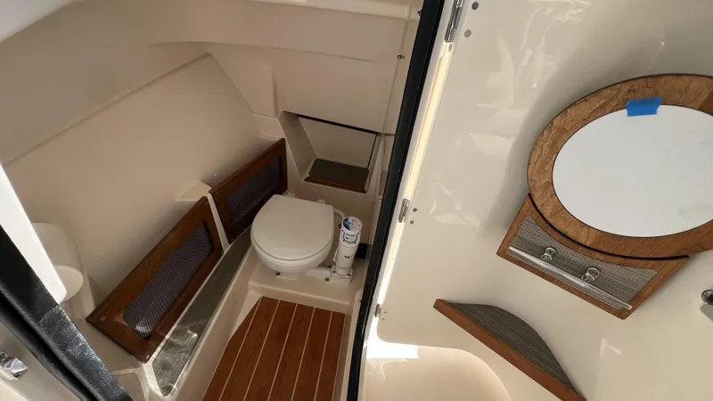 Slide: The Image of 2026 Grady-White GW 235 Freedom boat interior with toilet and mirror. - 18