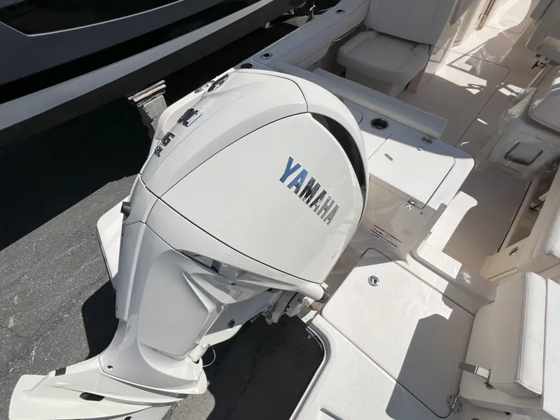 Slide: The Image of 2026 Grady-White GW 235 Freedom boat with Yamaha outboard motor, white interior. - 2
