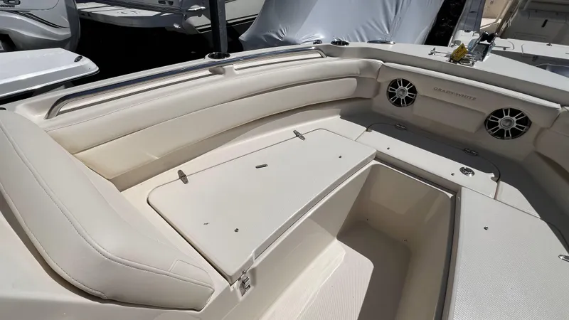 Slide: The Image of 2026 Grady-White GW 235 Freedom boat interior with cushioned seating and storage. - 20