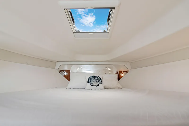 Slide: The Image of Interior cabin of 2004 Intrepid 377 Walkaround with skylight and bedding. - 30
