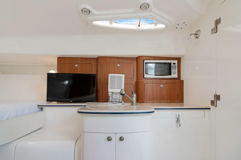 Slide: The Image of 2004 Intrepid 377 Walkaround interior with kitchenette, TV, and microwave. - 34