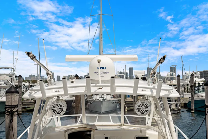 Slide: The Image of 2004 Intrepid 377 Walkaround docked at marina with city skyline in background. - 40