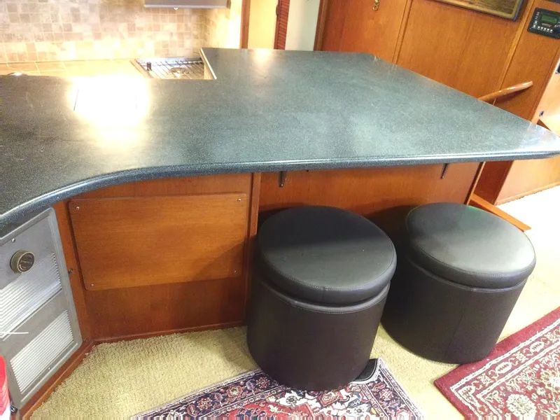 Slide: The Image of Interior of 1981 Tollycraft 43 Motoryacht with countertop and two black stools. - 17
