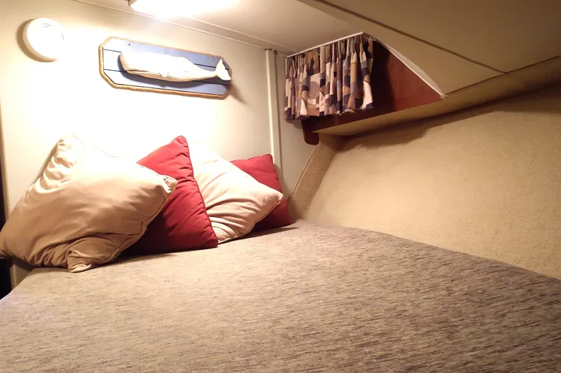 Slide: The Image of Cozy cabin interior of 1981 Tollycraft 43 Motoryacht with pillows and soft lighting. - 25