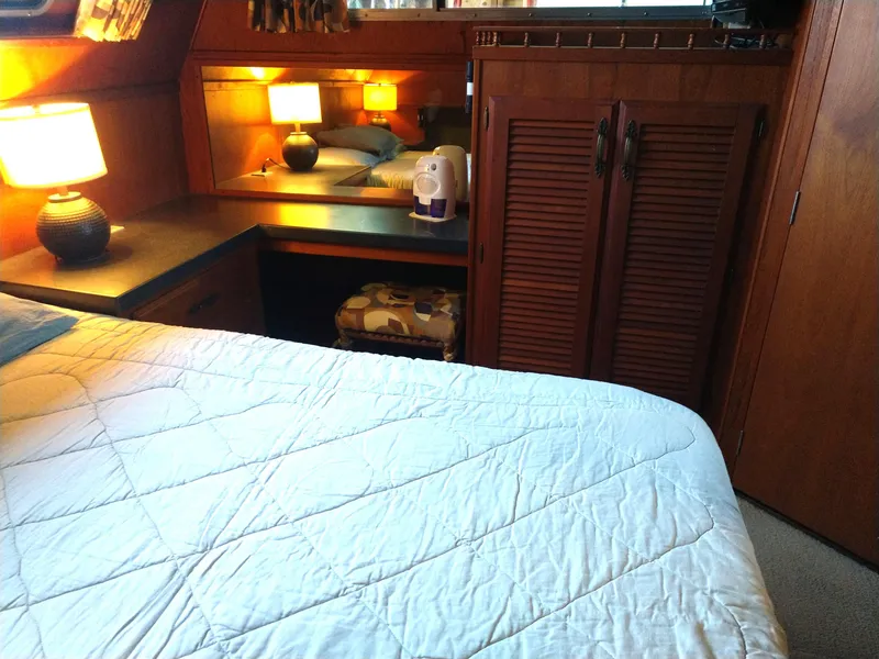Slide: The Image of Cozy bedroom interior of 1981 Tollycraft 43 Motoryacht with wooden cabinetry and soft lighting. - 26