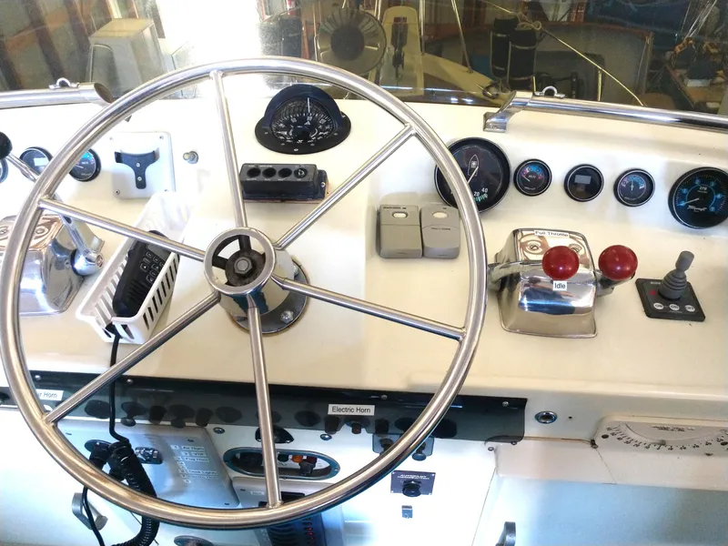 Slide: The Image of 1981 Tollycraft 43 Motoryacht helm with steering wheel and control panel. - 3