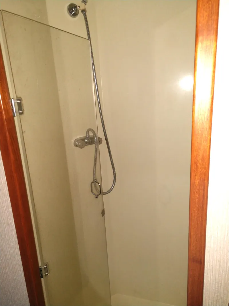 Slide: The Image of Shower area in 1981 Tollycraft 43 Motoryacht with glass door and handheld showerhead. - 31