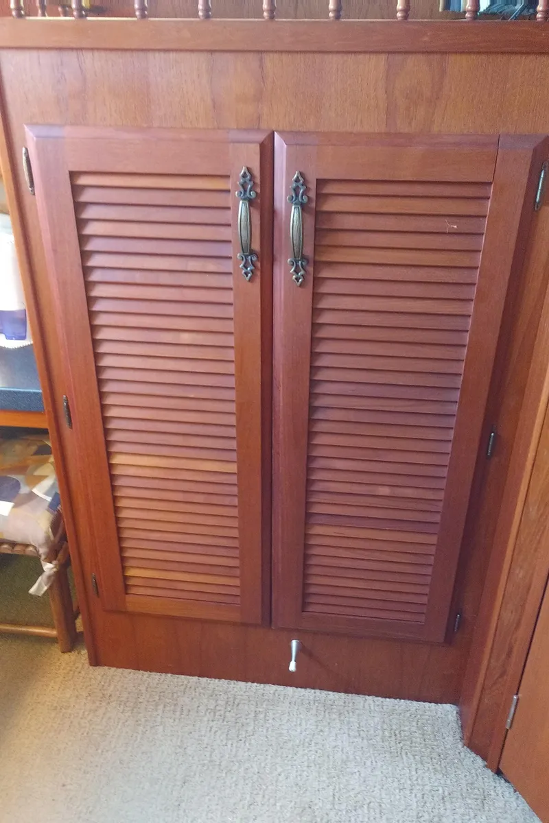 Slide: The Image of Wooden cabinet doors with ornate handles on a 1981 Tollycraft 43 Motoryacht. - 32