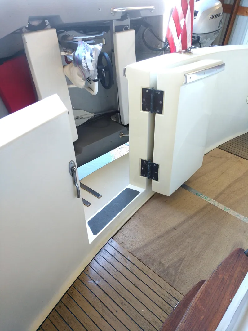 Slide: The Image of 1981 Tollycraft 43 Motoryacht interior with open door, wooden flooring, and steering wheel. - 36