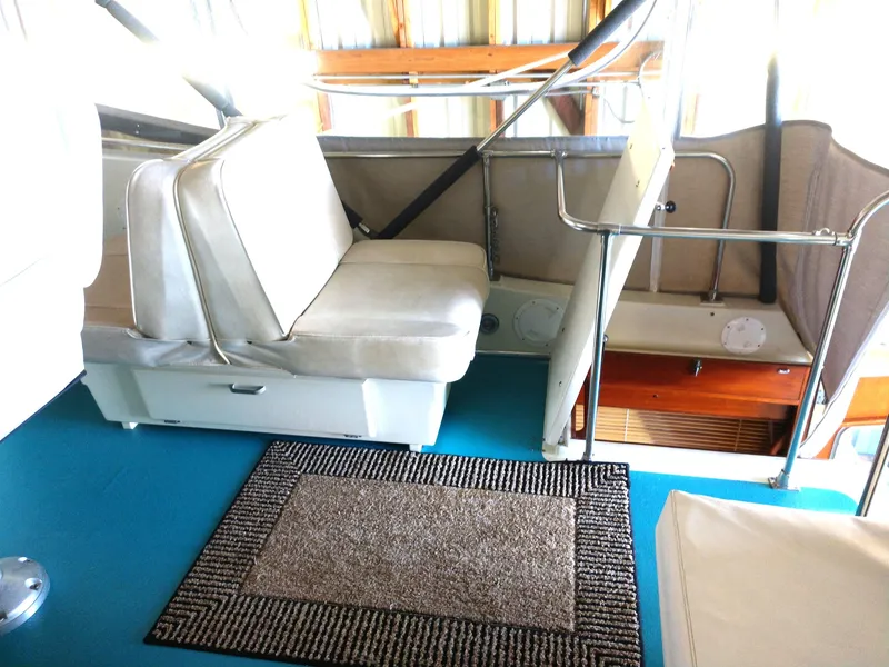 Slide: The Image of 1981 Tollycraft 43 Motoryacht interior with seating and carpeted floor. - 43