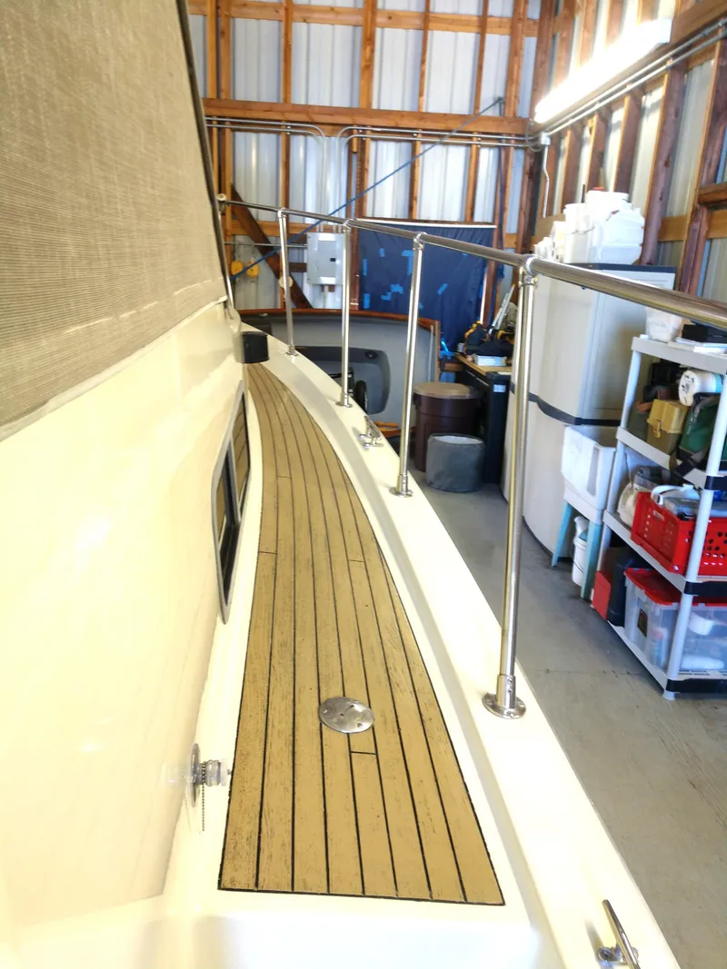 Slide: The Image of 1981 Tollycraft 43 Motoryacht in storage, showcasing deck and railing details. - 45