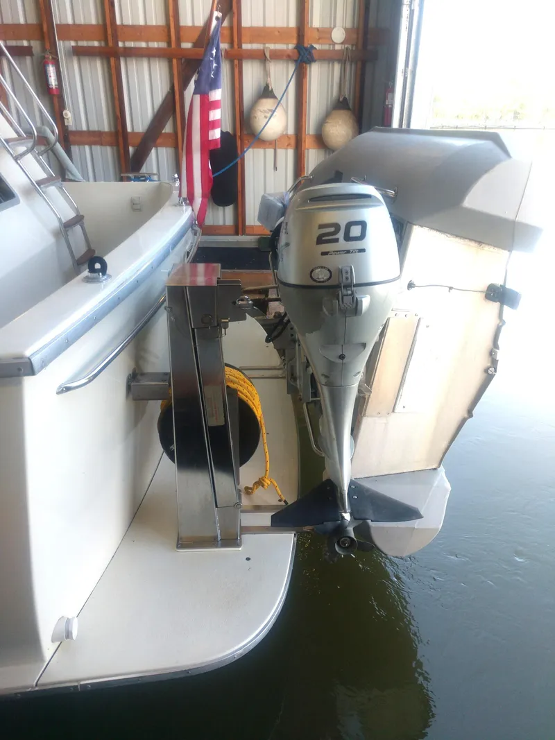 Slide: The Image of 1981 Tollycraft 43 Motoryacht with outboard motor in a marina setting. - 49