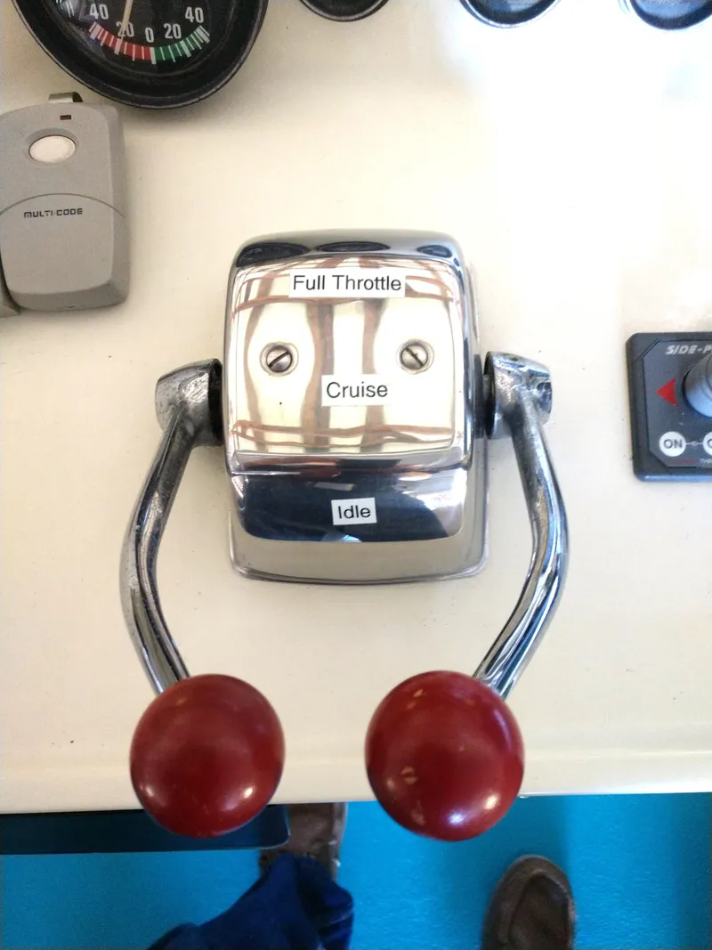 Slide: The Image of 1981 Tollycraft 43 Motoryacht throttle controls with red handles and labeled settings. - 7