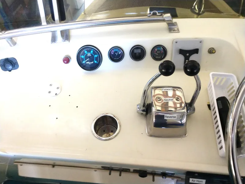 Slide: The Image of 1981 Tollycraft 43 Motoryacht control panel with gauges and throttle levers. - 8