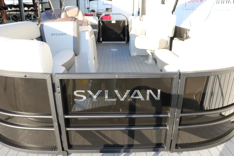 Slide: The Image of 2025 Sylvan Mirage X1 pontoon boat interior with seating and Sylvan branding. - 13